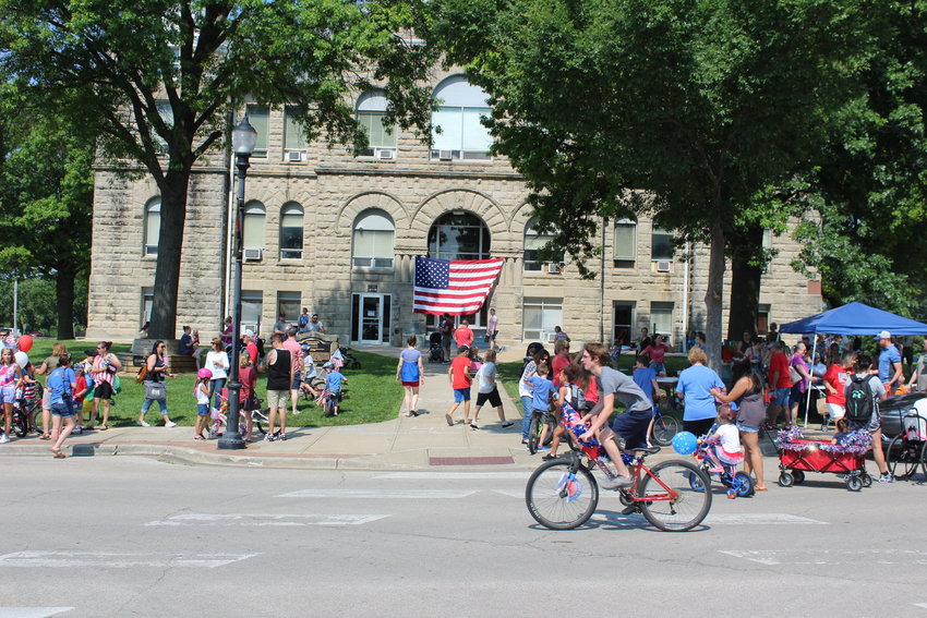 Participants ride their decorated bikes through downtown Warrensburg during the 2021 Patriotic Children&rsquo;s Bike Parade. Warrensburg Main Street will host the 2022 parade on Saturday morning, July 2.