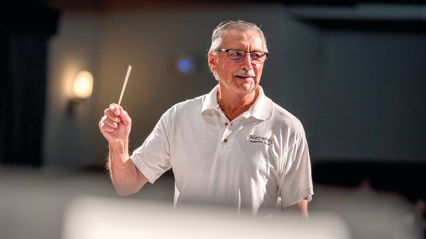 University of Central Missouri Professor Emeritus of Music Jim Gai, one of two conductors for the evening, leads the community band through a piece during the President&rsquo;s Lawn Concert on Monday, July 25, in Hendrick&rsquo;s Hall. The performance was moved indoors due to weather conditions.