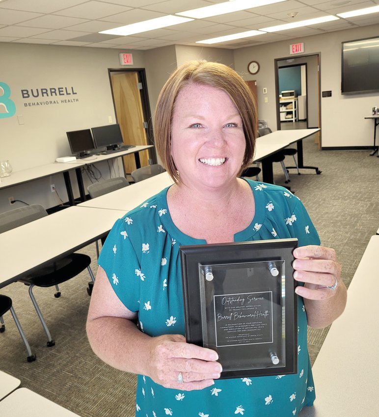 Burrell Behavioral Health Director of Crisis Services Carisa Kessler poses with a plaque received on behalf of Burrell during a 988 kickoff event. The plaque was presented by the Missouri Department of Mental Health and the Missouri Behavioral Health Council in recognition of Burrell&rsquo;s ongoing commitment to Missouri&rsquo;s 988 Task Force and dedication to advancing crisis services for their communities.