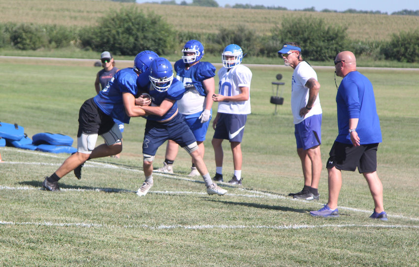 Holden football athletes participate in a run-based drill during practice Thursday, Aug. 11, at Holden&rsquo;s practice field.