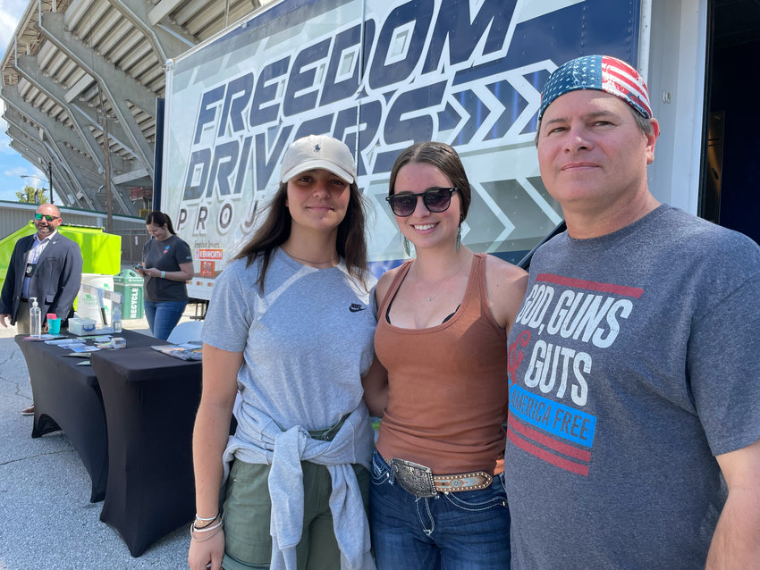 Clara Mufat Maridol, Grace Nation, and Wes Nation of Vandalia visit the Freedom Truckers exhibit Thursday at the fair.
