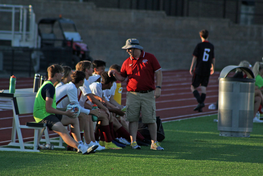 Warrensburg boys soccer head coach Matthew Bax speaks to Tigers on the bench during the preseason jamboree Tuesday, Aug. 23, at the Warrensburg Activities Complex.