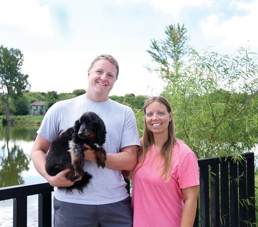 Colin and Meghan Funkhouser, owners of Funky Bunch Pet Care LLC, hold their 14-year-old dog Kobe on Monday at Clover Dell Park in Sedalia. They will host a Pet Loss Memorial at 9 a.m. Saturday, Sept. 24, at Clover Dell Park. Colin said they plan to make the event an annual memorial.