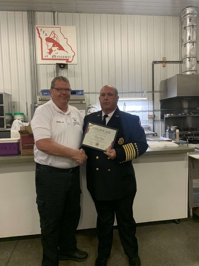 Public Information Officer Larry Eggen receives a certificate of appreciation from the Missouri State Fair Fire Department.