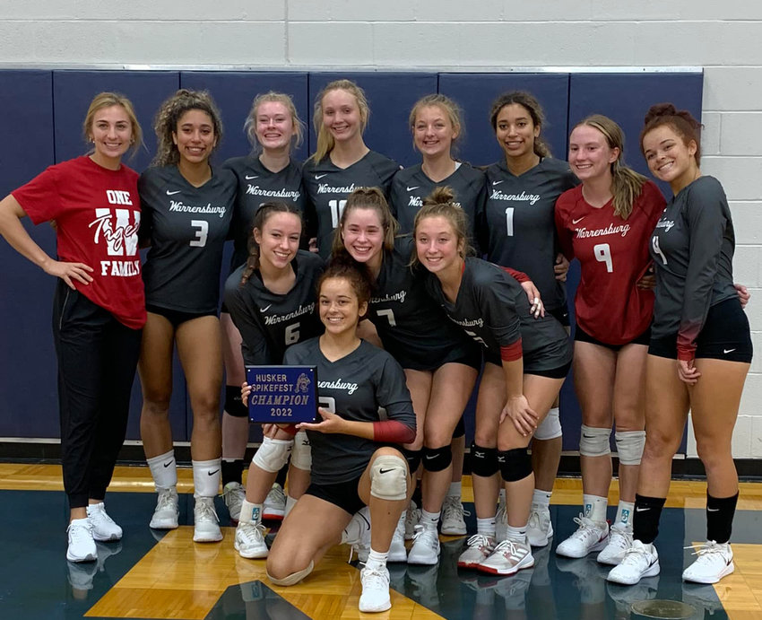 Warrensburg volleyball poses for a team photo with its Higginsville Spikefest championship plaque Saturday, Sept. 10, at Lafayette County High School.