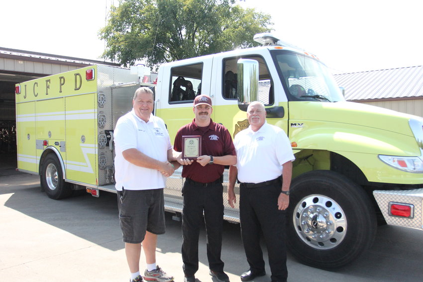 aining and Safety Lieutenant Blake Radmussen is presented with a plaque as EMS Provider of the Year for his service at the Missouri State Fair Fire Department. From left, Battalion Chief Larry Eggen, Radmussen and Fire Chief Larry Jennings.