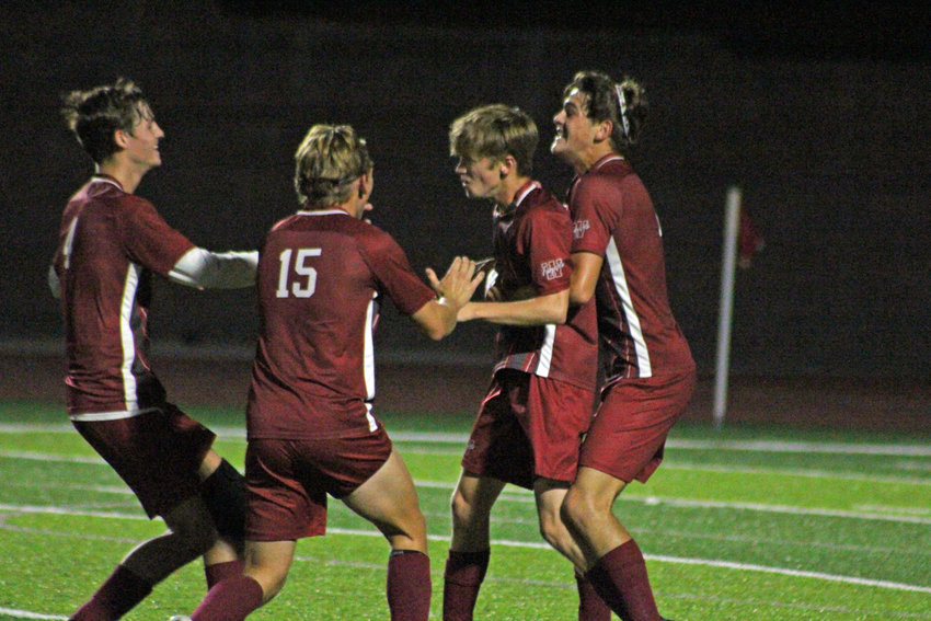 Warrensburg senior Owen Hall, junior Colby Heinrich, junior Austin Moses and junior Shaun McMurphy celebrate a game-winning goal from Moses against Odessa on Tuesday, Sept. 20, at the Warrensburg Activities Complex.