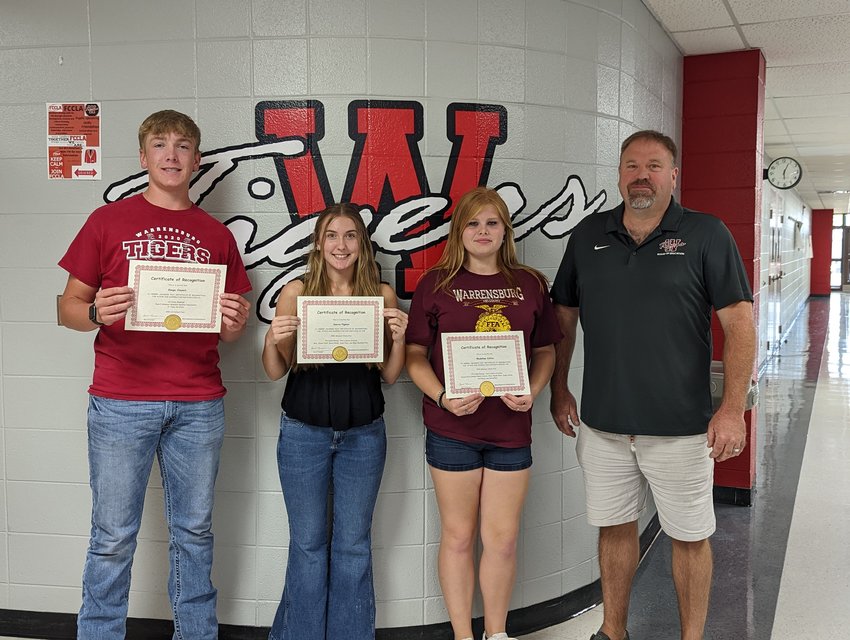 From left, students Gauge Claunch, Sierra Pigman and Madeline Collins are presented with certificates of recognition for their achievements by School Board President Matt Sergent.