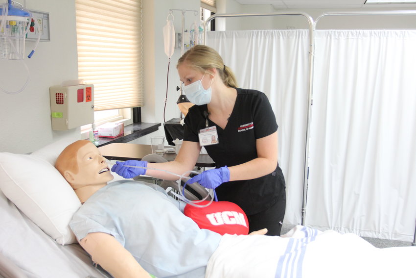 University of Central Missouri Nursing student  practices placing a tube.