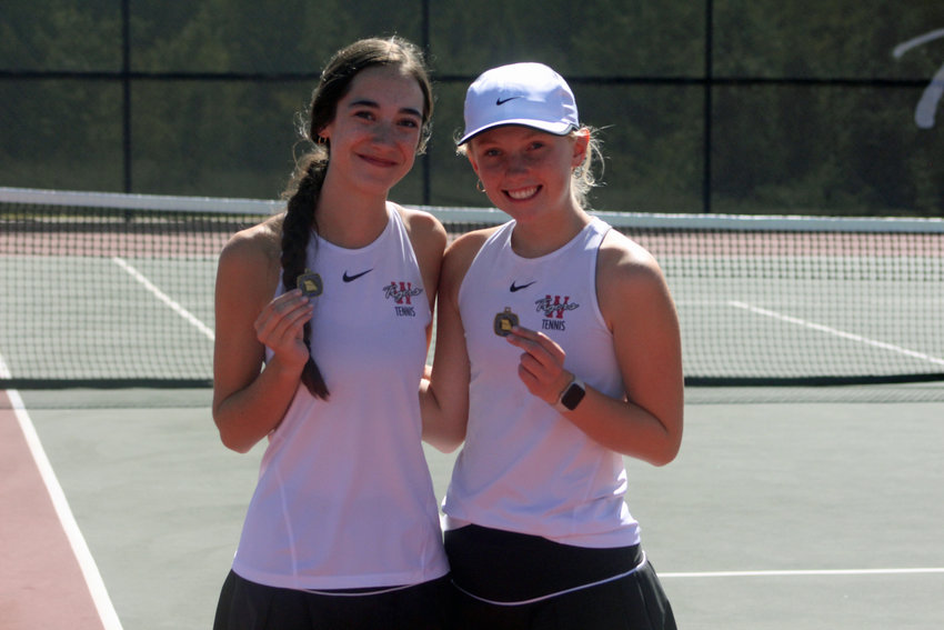 Warrensburg juniors Lilly Constant and Claire Thomas pose for a photo with their MRVC West No. 2 doubles championship medals Wednesday, Sept. 28, at the Warrensburg Activities Complex.