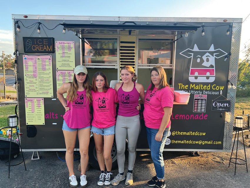 Malted Cow owner Alisha Moore, far right, and her three daughters, from left, Mackenzie Moore, Matty Moore and Lexy Moore, stand outside The Malted Cow, 208 E. Young St., on Wednesday, Oct. 5. The three daughters help Moore run the ice cream truck.