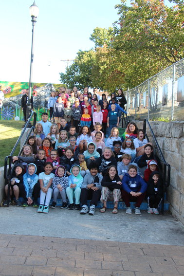 Martin Elementary School students, teachers and chaperones gather for a picture before a tour on Thursday, Oct. 13, of businesses in the downtown area.   PHOTO CREDIT: Photo courtesy of Warrensburg Main Street.