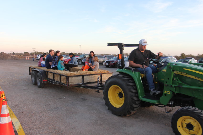 Event-goers head out on a non-scary hayride during Ghouls Night Out on Friday, Oct. 21, at the Johnson County Fairgrounds.