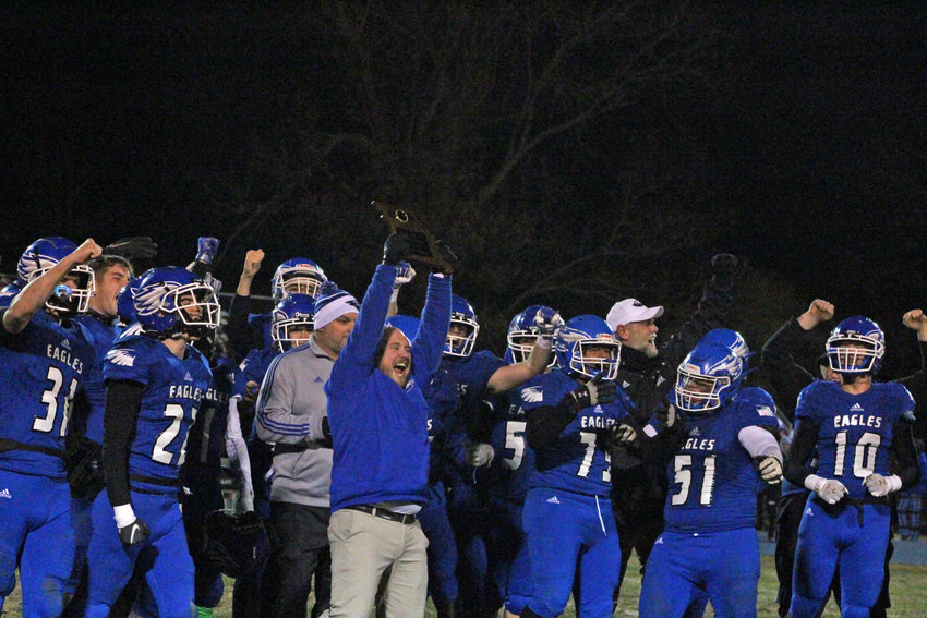 Holden head coach David Diener raises the MSHSAA Class 2 District 6 championship plaque following a win over Pembroke Hill on Friday, Nov. 11 at Holden High School.