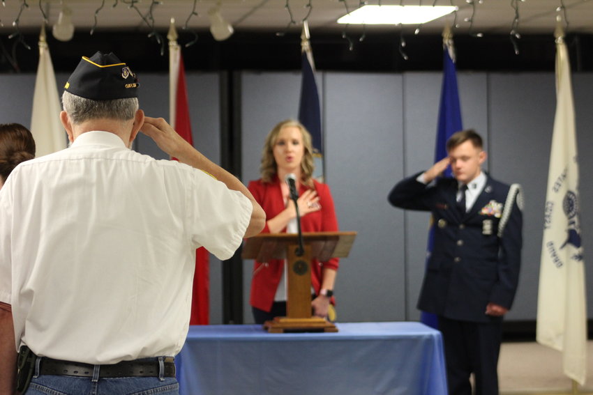 American Legion Chaplin Doctor Tom Patterson salutes as Lauren Vesecky sings the national anthem at the American Legion Matthews-Crawford Post 131 Veterans Day Ceremony on Friday, Nov. 11.