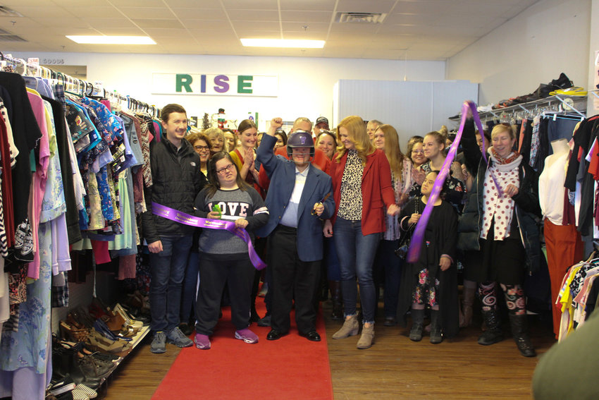Brandon Brown cuts the ribbon surrounded by RISE Racks Thrift Store employees, community members and Warrensburg Chamber of Commerce members on Friday, Nov. 18 at the grand opening and ribbon cutting for RISE Racks, 1125 N. Simpson Drive Suite K. RISE Racks provides hands-on job training for individuals with various abilities and sells affordable community-donated items, which supports RISE Community Services.