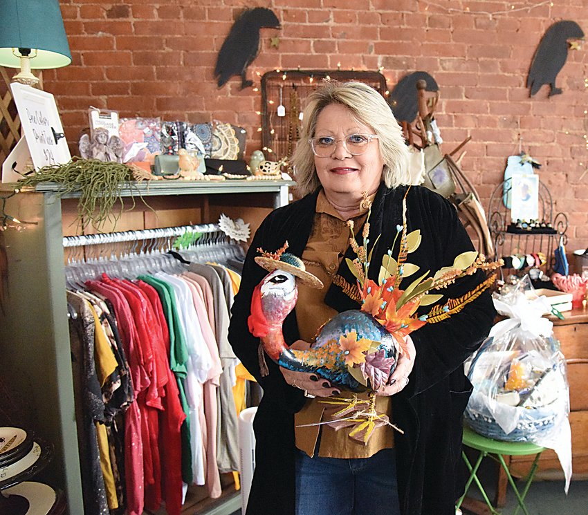On Thursday, Nov. 17, Rose Anne Scrogin-Livengood, owner of Raven&rsquo;s Nest Antiques &amp; Things in Windsor, holds a turkey created from a gourd by artist Betty Reed. The newly opened shop has 28 vendors and a wide assortment of gift items.