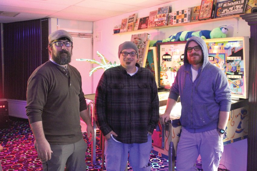 From left, Jed Rhodes, Bryan Chamberlin and Ryan Edmondson, owners of Retrograde, stand inside the arcade on Wednesday, Nov. 23.