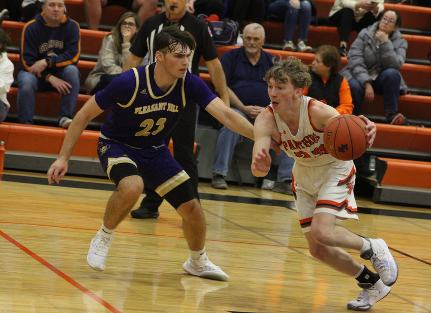 Knob Noster junior Lucas Martin drives the ball down court against Pleasant Hill on Tuesday, Dec. 6, at Knob Noster High School.