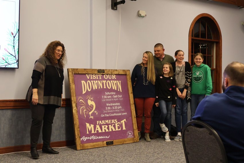 Heather and Buck Counts and their children, of Buckeye Acres, share smiles as they receive the Farmers' Market Legacy Award at Warrensburg Main Street&rsquo;s Evening of Excellence on Tuesday, Jan. 24.   Photo by Meliyah Venerable | Star-Journal