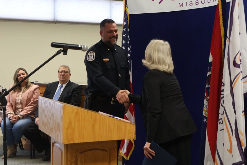 City Clerk Jodi Schneider and Police Chief Andy Munsterman shake hands after Munsterman is sworn in on Jan. 27 at the Warrensburg Municipal Center.