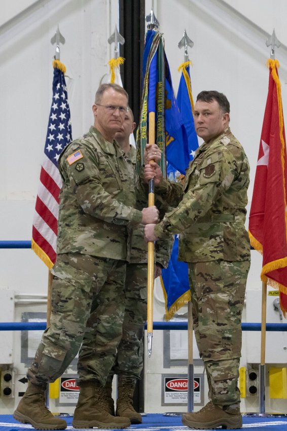 Maj. Gen. Levon Cumpton, Adjutant General of the Missouri National Guard, presents the 131st Bomb Wing guidon to new wing commander Col. Jared P. Kennish, during a change of command ceremony at Whiteman Air Force Base, Missouri, Feb. 3. During the ceremony Col. Jared P. Kennish assumed command of the 131st Bomb Wing from Col. Matthew D. Calhoun.