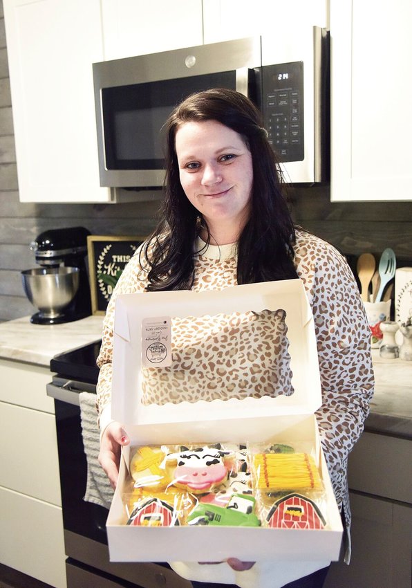 On Wednesday, Feb. 22, Jessica Blankenship, owner of Charm House Cookies, stands with a box of specialty cookies that are individually heat-sealed. Blankenship said sealing the cookies works well if one wants them shipped.