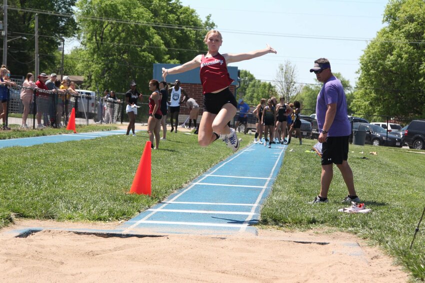 Warrensburg junior Grace Hill completes a long jump attempt during the Class 4 District 7 championship on May 14, 2022, at Grandview High School.