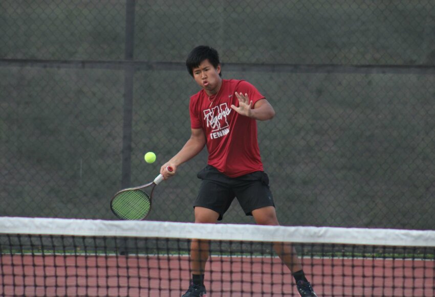 Warrensburg senior Qi Huang swings into an attack in a dual against Harrisonville on Tuesday, April 25, at the Warrensburg Activities Complex.