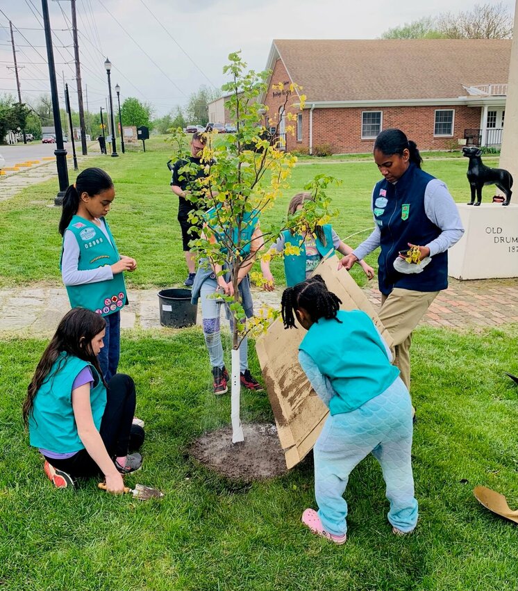 Junior Scouts from Girl Scout Troop 2969 of Whiteman Air Force Base, Knob Noster, and Warrensburg plant a Rising Sun Redbud on Friday, April 28 in front of the historic old Johnson County Courthouse, 302 N. Main St., as part of an Arbor Day celebration. The event was a cooperative effort with the City of Warrensburg Tree Board and Energy and Sustainability Task Force, Johnson County Historical Society, CEAburg and the University of Central Missouri.   Photo courtesy of Bruce Uhler