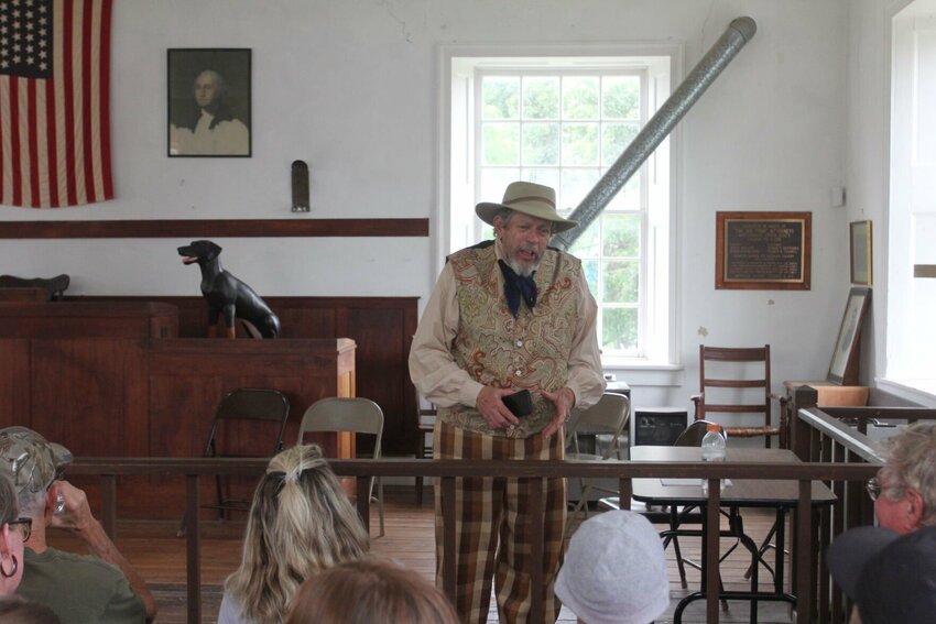 Bill Wayne tells the story of Old Drum in the historic Johnson County Courthouse on June 10. Wayne went into detail about the history of the dog and read the &quot;Eulogy of the Dog.&quot; This eulogy was read in the same courthouse during the Old Drum court case in 1870.