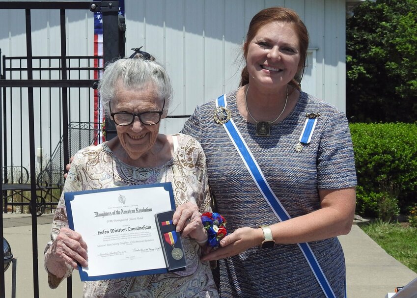 MSSDAR State Regent Renee Pace presents the National Defense Distinguished Citizen Award to Helen Cunningham.   Photo courtesy of Warrensburg chapter DAR