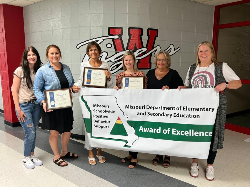 From left, Lauren Bunting, Beth Tiller, Ashley Klein, Nancy Rogers and Lorna Cassell pose with awards for PBIS at the Warrensburg Board of Education meeting on Tuesday, June 20.