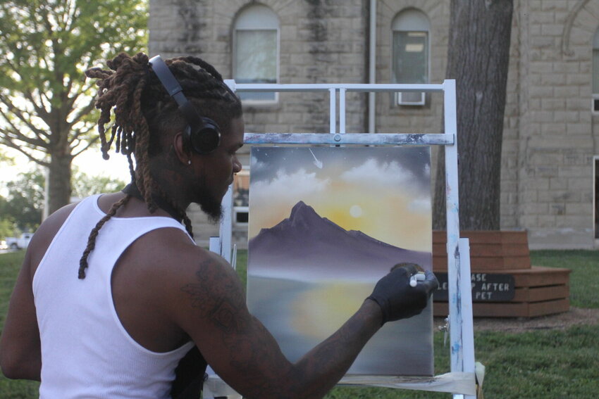 T.V. of They Watch TV LLC, paints live at the June 22 Art Walk in downtown Warrensburg. T.V. is a traveling tattoo artist and painter.&nbsp;