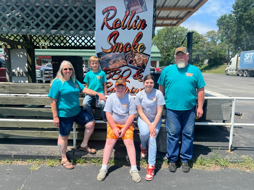 From left, Cindy Dean, Ryder Dean, Trenton Cockrum, Kiera Rudzik and Steve Riska stand in front of Rollin Smoke BBQ and Catering's new location, 1034 S. Maguire St. in Warrensburg.