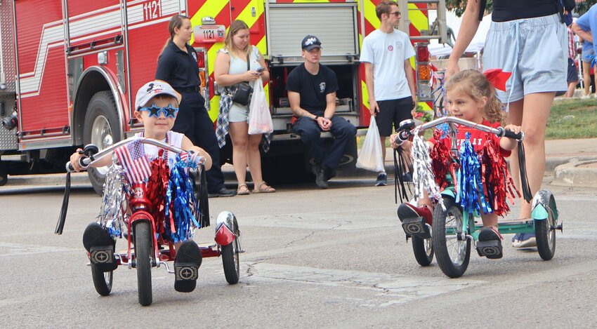Two children bike through downtown Warrensburg on matching bicycles on Saturday, July 1.&nbsp;