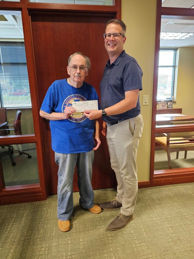 The Early-Bird Rotary Club in Warrensburg responded to a call for help from community organizations to support the purchase of fans and air conditioners for those in need this summer. Pictured are Early-Bird President Don Loar and Vice President Greg Hall with a check for $750 for Missouri Valley Community Action Agency's fan and air conditioner fund.