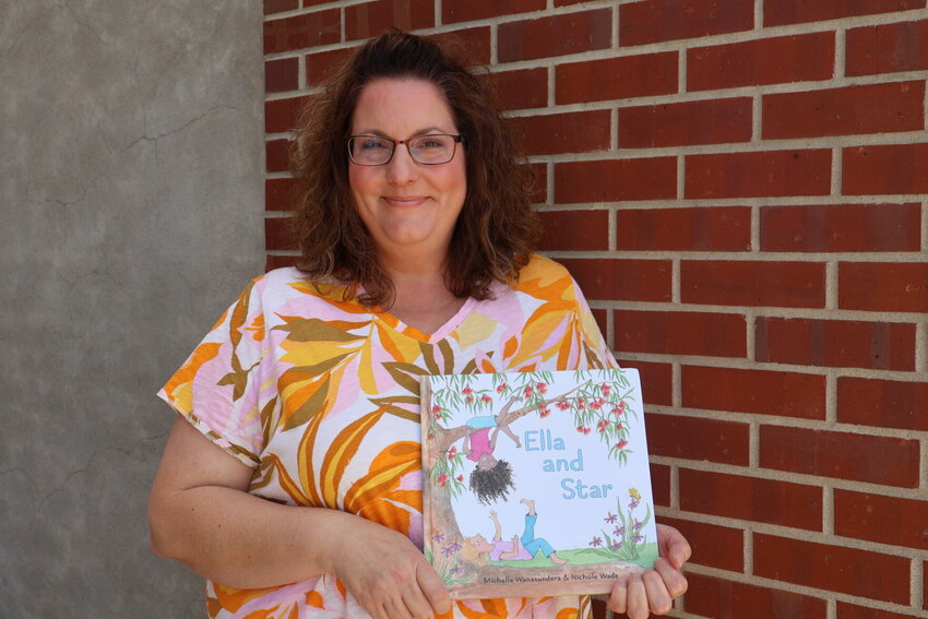 Nichole Wade poses with her first book, &quot;Ella and Star.&quot;&nbsp;