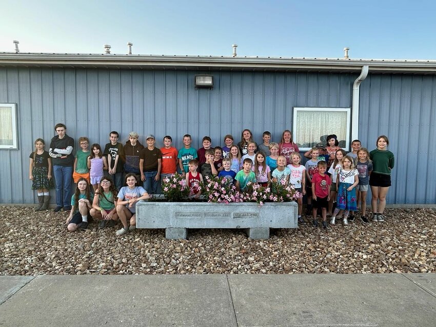 The 4-H Mt. Moriah chapter completed a project to upgrade the landscaping in front of the Johnson County Fairgrounds Rural Youth Community Center. Members of the 4-H group cleaned the area and installed landscaping rock and four concrete planters with flowers. Several area businesses helped make the project possible. Wildscapes LLC provided discount pricing on the landscaping rock, Midwest Cast Products donated four concrete castings to be used for flower planters, and FCS Financial provided a grant to fund the project.
