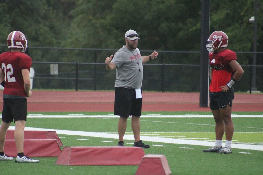 Warrensburg head coach Chris Cavanah instructs athletes during practice Monday, Aug. 14, at the Warrensburg Activities Complex.