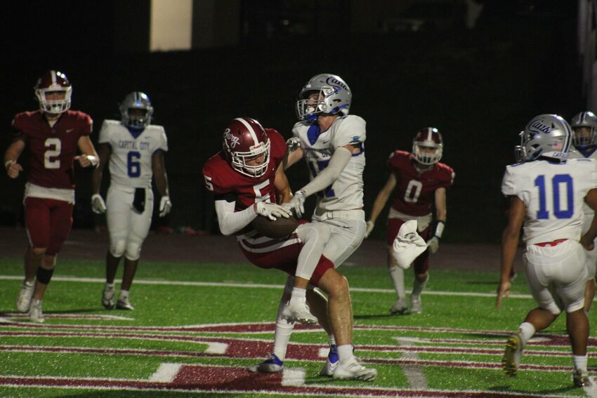 Warrensburg junior wide reciever Ty Carman hauls in a touchdown reception against Capital City on Friday, Aug. 25, at the Warrensburg Activities Complex.