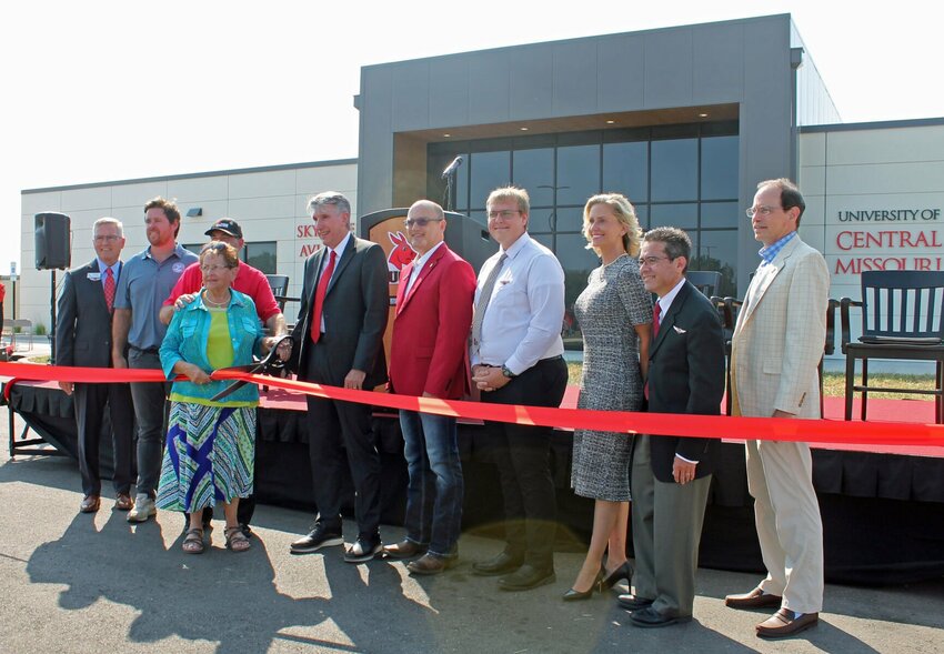 State officials and University of Central Missouri representatives celebrate the opening of the University of Central Missouri's new Skyhaven Aviation Center with a ribbon cutting Friday afternoon, Sept. 8. From left, David Pearce, UCM executive director for governmental relations; Scott Fitzpatrick, Missouri state auditor; Warrensburg residents Lynn and Jackie Harmon; Roger Best, university president; state Sen. Denny Hoskins, Missouri District 21; Tyler Young, senior professional pilot student from Troy; Courtney Goddard, vice president for advancement and executive director of the UCM Alumni Foundation; Mark Suazo, dean of the Harmon College of Business and Professional Studies; and Ed Hassinger, Missouri Department of Transportation deputy director and chief engineer.
