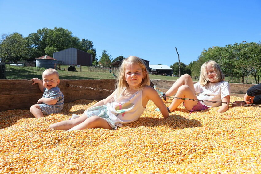 Siblings Marline, Milly and Margo pose in the corn pit at Buckeye Acres on Sunday, Sept. 24 for opening weekend of the pumpkin patch. The pumpkin patch at Buckeye Acres will be open Fridays, Saturdays and Sundays through the last weekend in October.