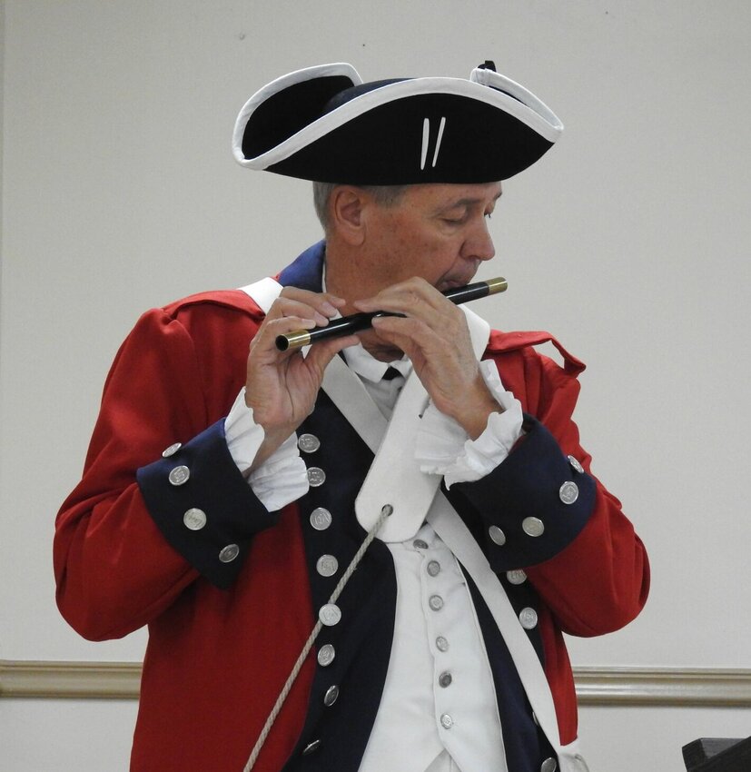 Roy Hutchinson plays a tune on the fife at the Oct. 13 meeting of the Daughters of the American Revolution, Warrensburg Chapter.