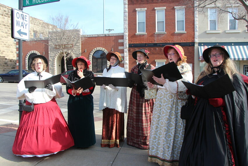 Merry Maidens carol along the streets of downtown Warrensburg during Dickens' Christmas in 2022. This year's event will be hosted Saturday, Dec. 2.