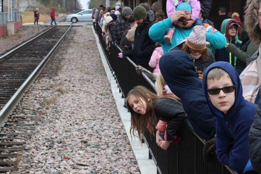 Children of all ages lean over the railing, waiting for the opportunity to meet Santa Claus on Saturday, Dec. 2, at the Warrensburg Station.