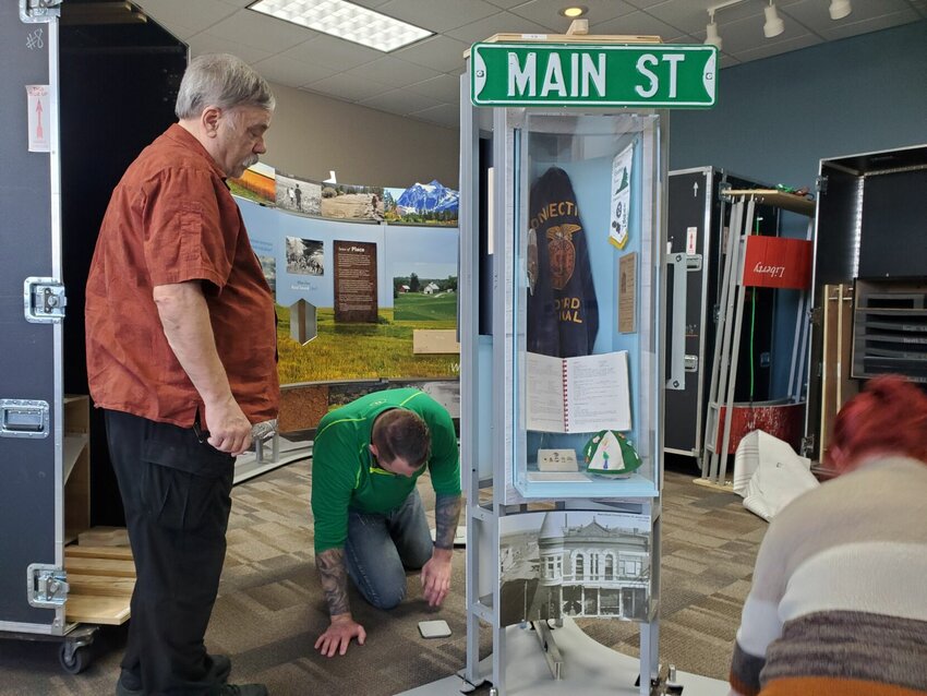 Former Knob Noster Mayor Tom Charrette, left, helps build a piece of the &quot;Crossroads: Change in Rural America&quot; exhibit Thursday, Dec. 14, at the Trails Regional Library in Knob Noster. The exhibit opens Monday, Dec. 18.