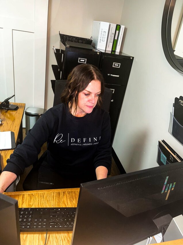 ReDefine staff member Jen Miles helps a client recently at the business, 220 Maynard St. in downtown Warrensburg.