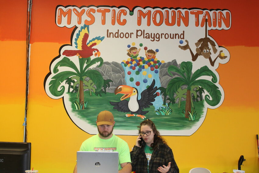 Ashton and Brandon Neel prepare for an upcoming session at Mystic Mountain Indoor Playground. The logo on the wall was painted by Jessica Neel, owner of Soul, Body, Art Tattoo studio, 401 Angus Lane in Knob Noster.