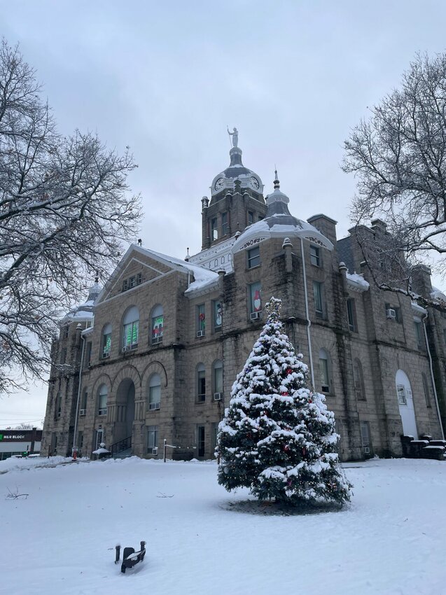 The Johnson County Courthouse sits glazed with snow on its lawn and Christmas tree on Tuesday, Jan. 9, in Warrensburg.&nbsp;